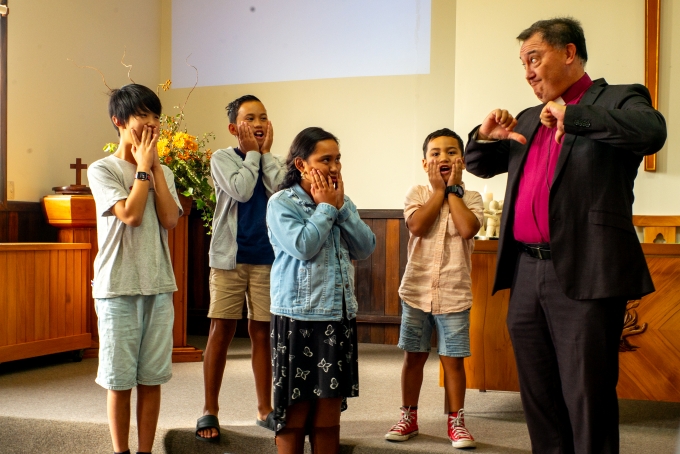 Children joining in and participating with Rev Tokerau during a Sunday service